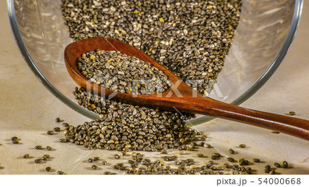 Glass container and wooden spoon with chia seeds 54000668