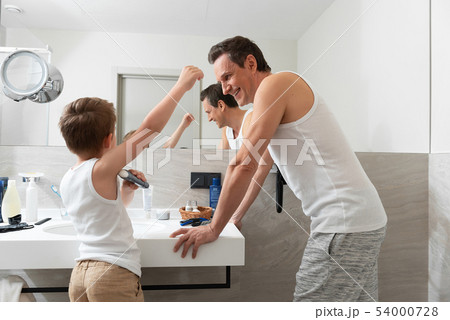 Little son using deodorant in the bathroom Little son using deodorant in the bathroom 54000728
