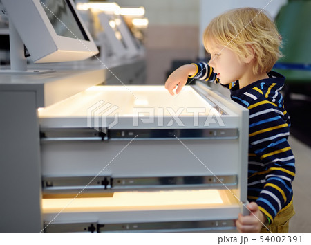 Little ?aucasian boy is looking an exposition in a 54002391