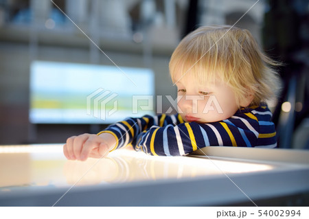 Little ?aucasian boy is looking an exposition in a 54002994