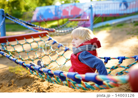 Cute little blond caucasian boy having fun on Cute little blond caucasian boy having fun on 54003126