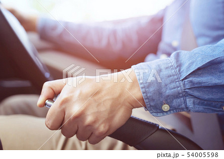 Closeup of person hand pulling handbrake  54005598