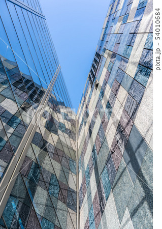 low angle view of skyscrapers with stone wall and low angle view of skyscrapers with stone wall and 54010684