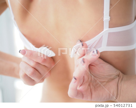 Girl taking off bra, cutting her lingerie with - Stock Photo [20710832]  - PIXTA