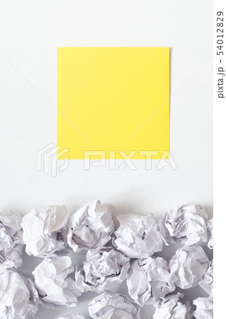inspiration white crumpled paper ball yellow note 54012829