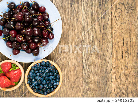 Fresh Summer Berries on Rustic Wooden Background 54015305