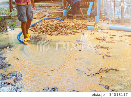 broken pipe in hole with water motion at roadside 54018117