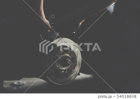 Disc brake and asbestos brake pads at car garage Disc brake and asbestos brake pads at car garage 54018638