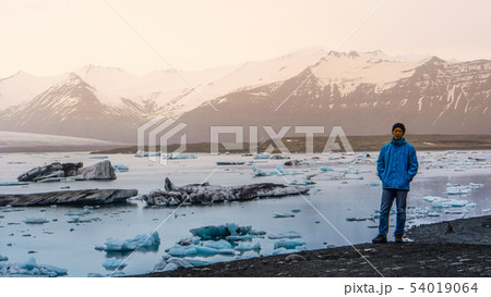 Asian man at majestic glacier lagoon Iceland trip 54019064