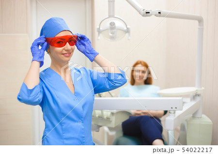 Dentist examining a patient's teeth in the dentist Dentist examining a patient's teeth in the dentist 54022217