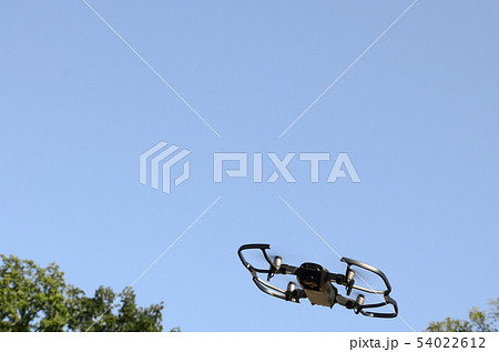 Drone with photocamera take off from land and 54022612