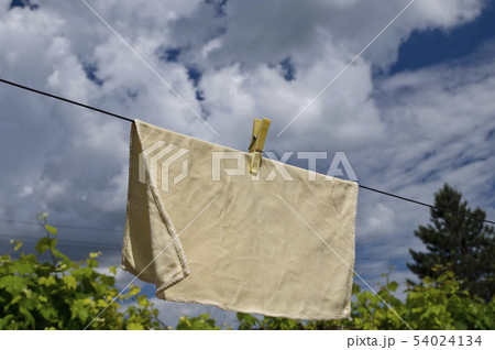 Clothes peg on a blue towel and washing line 54024134