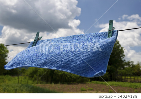 Clothes peg on a blue towel and washing line 54024138