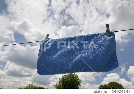 Clothes peg on a blue towel and washing line 54024140