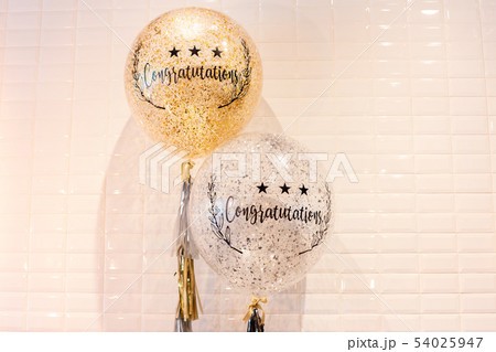 Word congratulation on balloons white tile wall background. 54025947