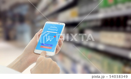 Woman using smart phon while shopping in Woman using smart phon while shopping in 54038349