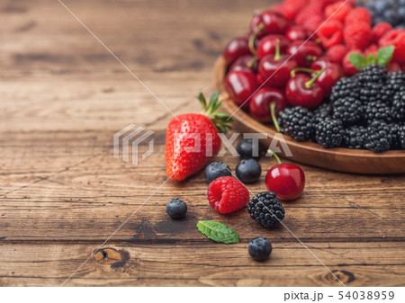 Fresh organic summer berries mix in round wooden Fresh organic summer berries mix in round wooden 54038959