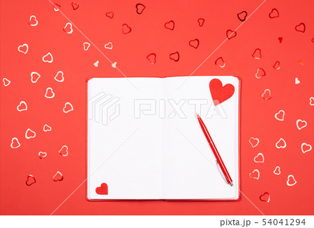 Notebook with pen on red background with Notebook with pen on red background with 54041294