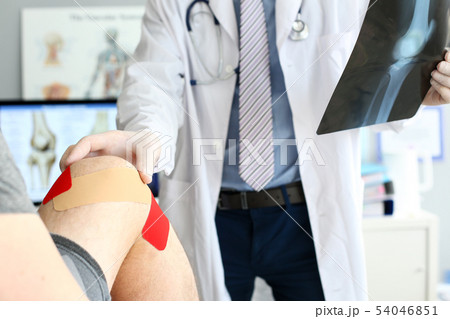 Doctor helping patient Doctor helping patient 54046851