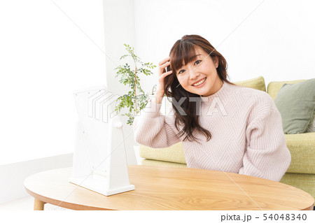 髪の毛のケアをする若い女性 髪の毛のケアをする若い女性 54048340