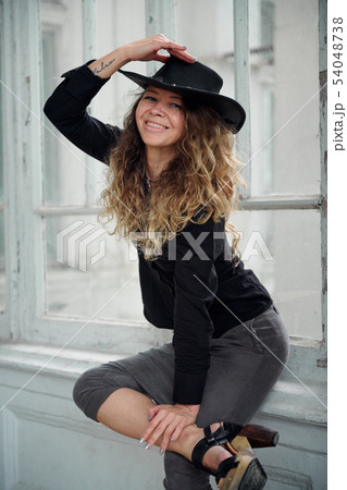 fashionable girl dressed in black shirt, hat and fashionable girl dressed in black shirt, hat and 54048738