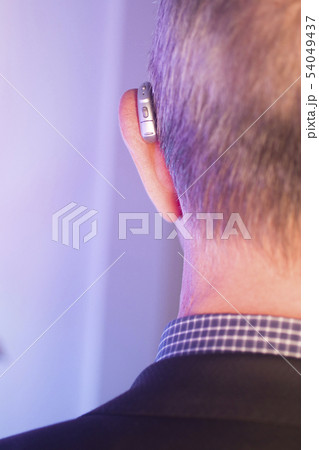 Man with hearing aid 54049437