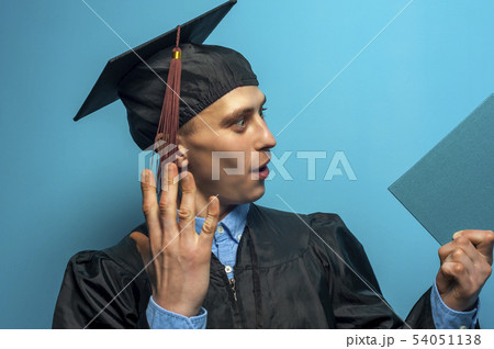 Happy Graduate man holding up a diploma 54051138