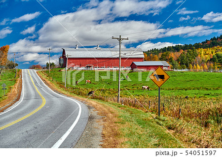Highway and red barn at sunny autumn day 54051597
