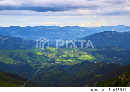 Bright rolling countryside around a farm in the morning light. Picturesque day and gorgeous scene 54053911