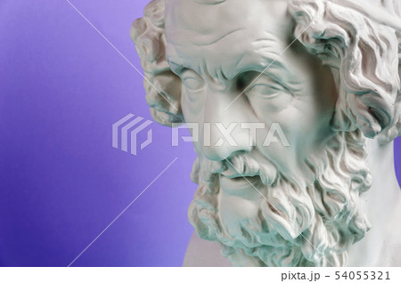 Gypsum copy of ancient statue Homer head on a blue background. Plaster sculpture man face. 54055321