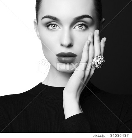 beautiful young woman with big ring pose in studio 54056457