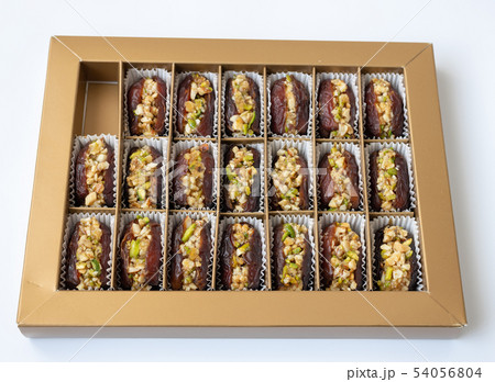 Dates stuffed with pistachios in a box Dates stuffed with pistachios in a box 54056804