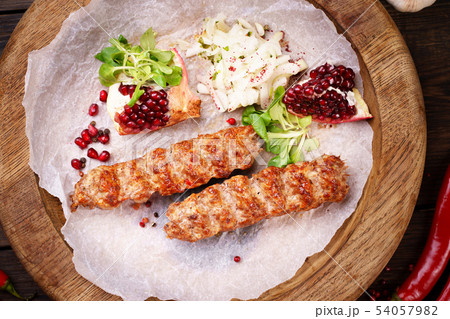 Traditional Adana kebab on wooden plate Traditional Adana kebab on wooden plate 54057982