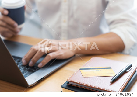 Man paying with credit card and entering security 54061084