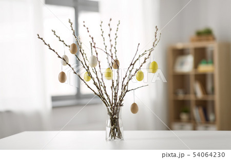 pussy willow branches decorated by easter eggs 54064230