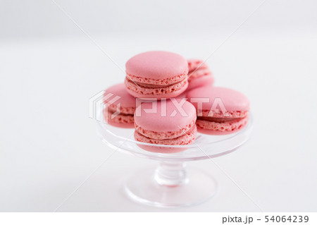 pink macarons on glass confectionery stand 54064239