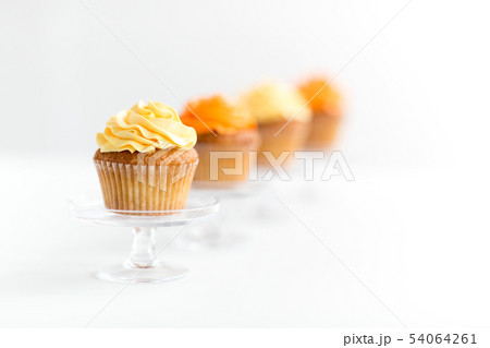 cupcakes with frosting on confectionery stands cupcakes with frosting on confectionery stands 54064261