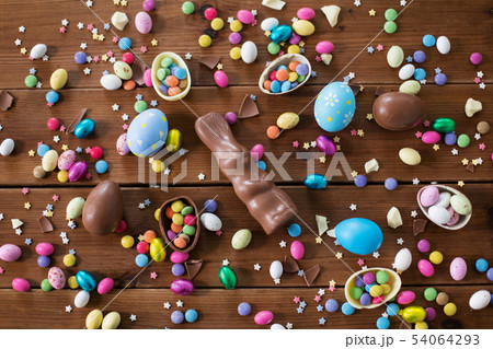 chocolate eggs, easter bunny and candies on wood 54064293