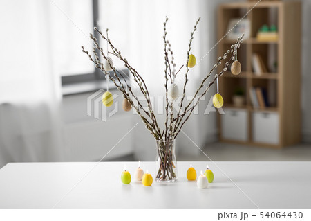 pussy willow branches decorated by easter eggs 54064430
