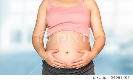 Pregnant woman at hospital health check up. Pregnant woman at hospital health check up. 54065407