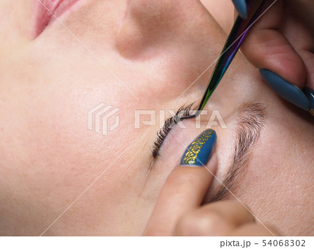 Eyelashes with tweezers Eyelashes with tweezers 54068302