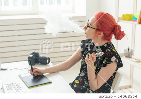 graphic designer concept - Female graphic designer working on computer while using graphic tablet at 54068554