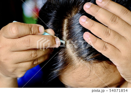 Women gray hair removal by herself. 54071854