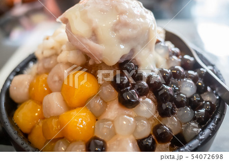 eating shaved ice with colorful dessert 54072698