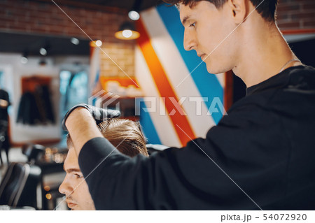 Stylish man sitting in a barbershop Stylish man sitting in a barbershop 54072920