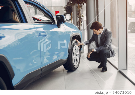 Handsome and elegant man in a car salon 54073010