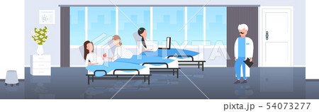 male doctor examining pregnant women lying in hospital bed gynecology consultation pregnancy concept 54073277