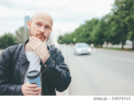 Adult attractive bald bearded man with paper cup Adult attractive bald bearded man with paper cup 54074315