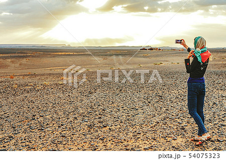 Young woman takes a selfie on her smartphone on Young woman takes a selfie on her smartphone on 54075323