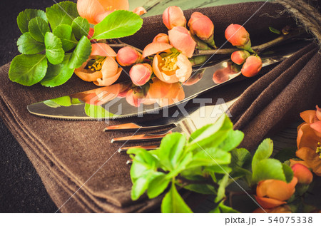 Vintage table setting with delicate flowers on rustic shabby table. 54075338